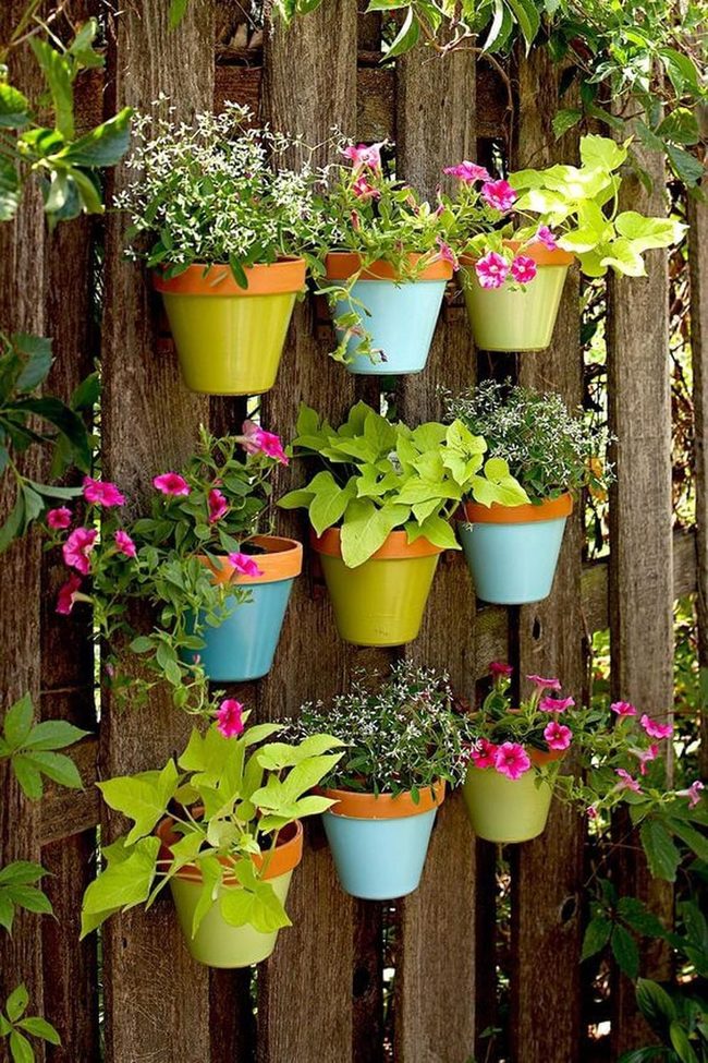 Painted Clay Pots On Fence