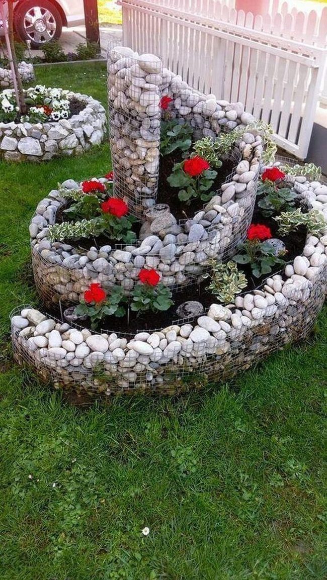 Red Geraniums In Spiraling Stone