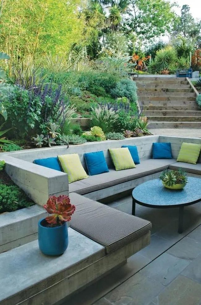 Concrete Benches, Blue Pillows, Verdant Walls