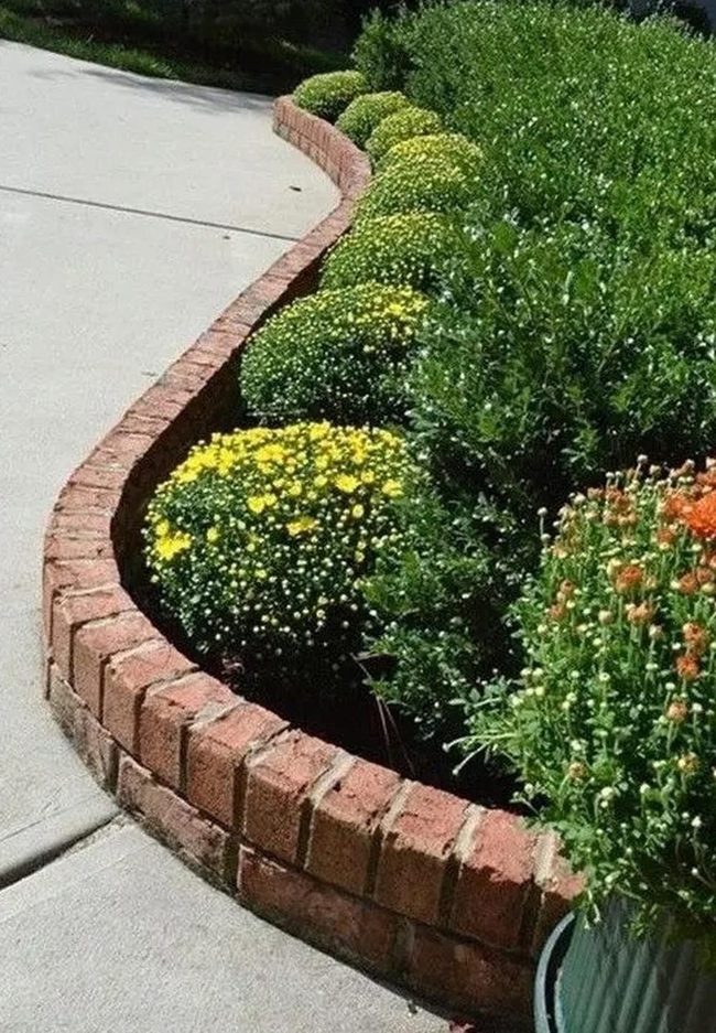 Orange Flowers Brighten Curved Brick Gardens