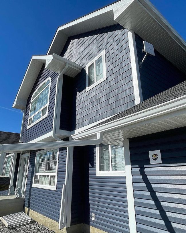 Deep Blue Siding With White Shingle Details