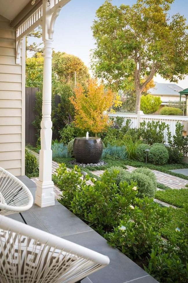 Dark Fountain Garden With White Railings