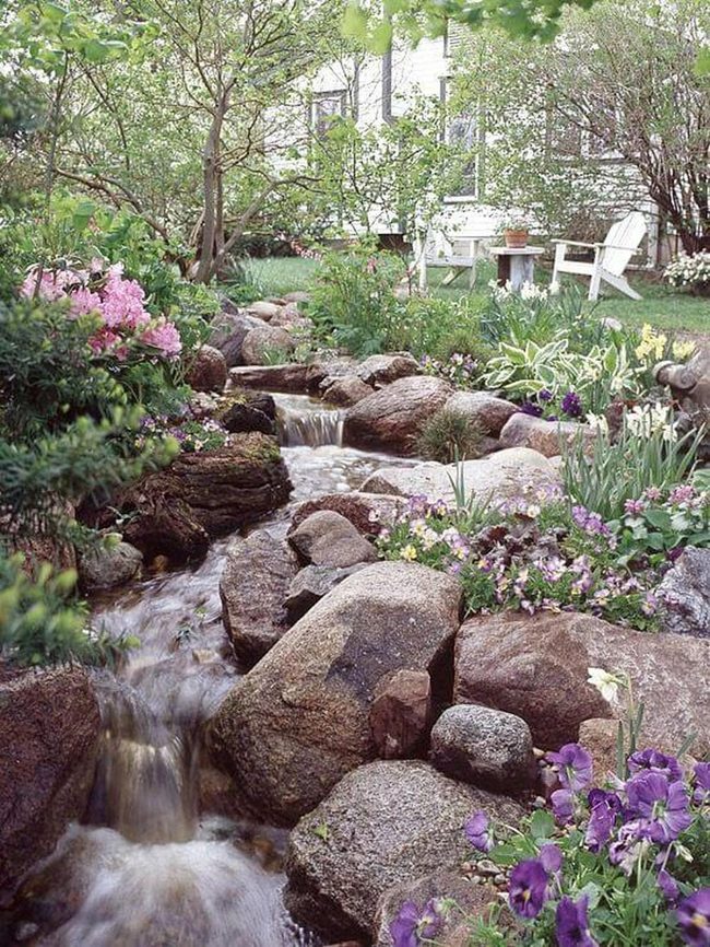 Cascading Water With Vibrant Garden Plants
