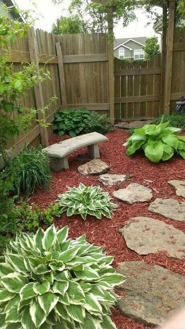 Stone Benches Among Lush Hostas