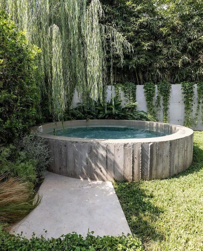 Circular Water Pool Among Blooming Plants
