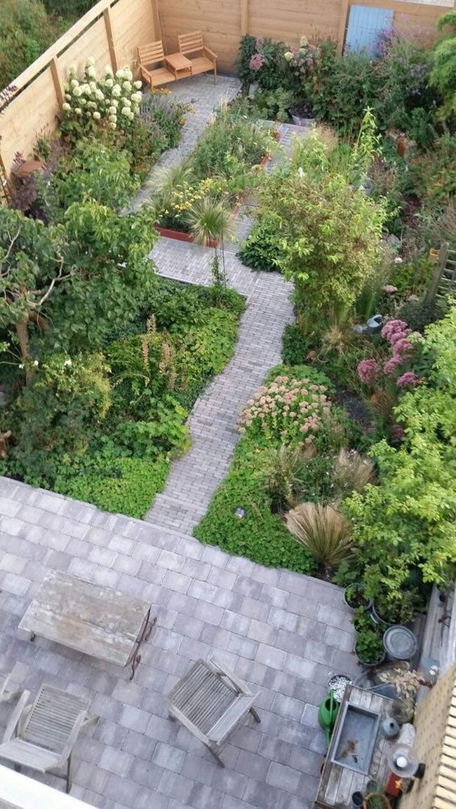 Colorful Garden Sanctuary With Wooden Seating