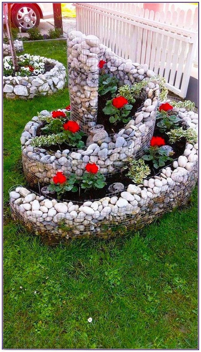 Red Geraniums Through Stone Spirals
