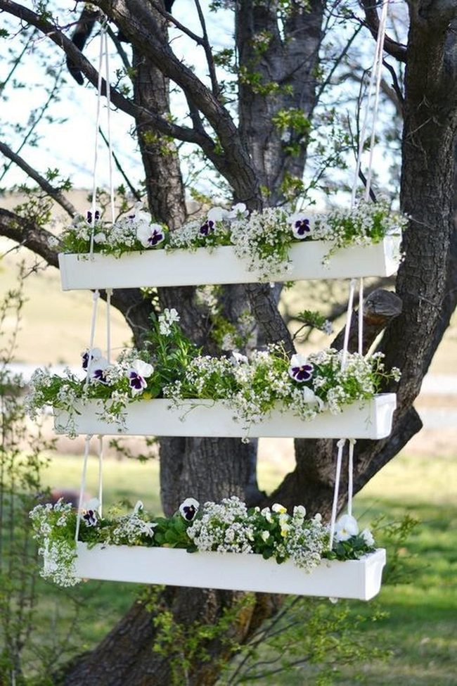White Planters Hang From Natural Branches