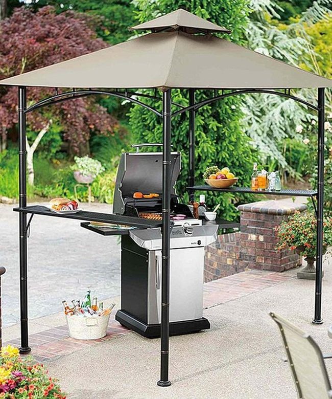Black Metal Grill Under Beige Canopy