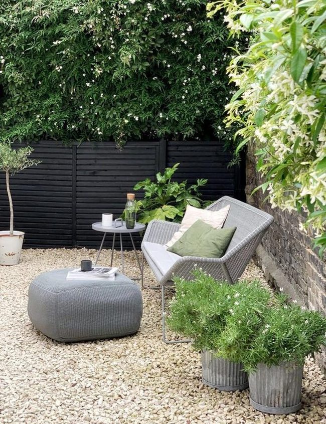 Gray Seating Among Vibrant Greenery