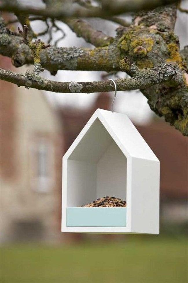 White Birdhouse On Mossy Branch