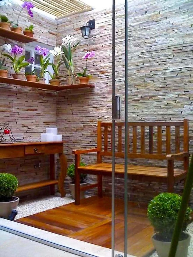 Wooden Bench Among Flowering Terracotta