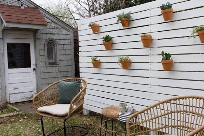 Potted Greenery Softens Wooden Fences